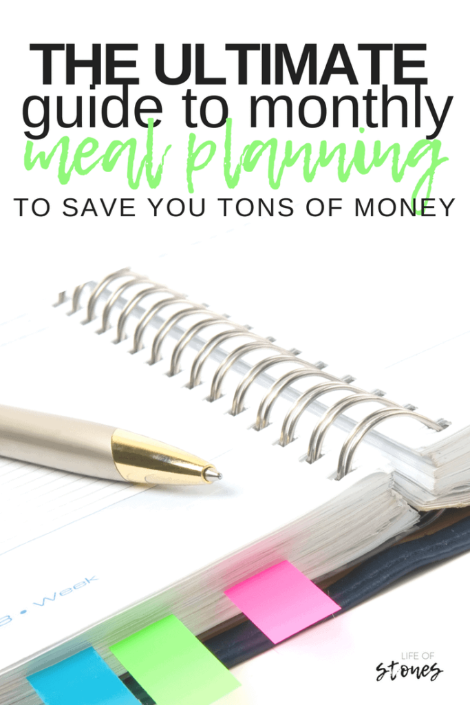 Spiral notebook with colored tabs and a pen with text that reads: The ultimate guide to monthly meal planning to save you tons of money
