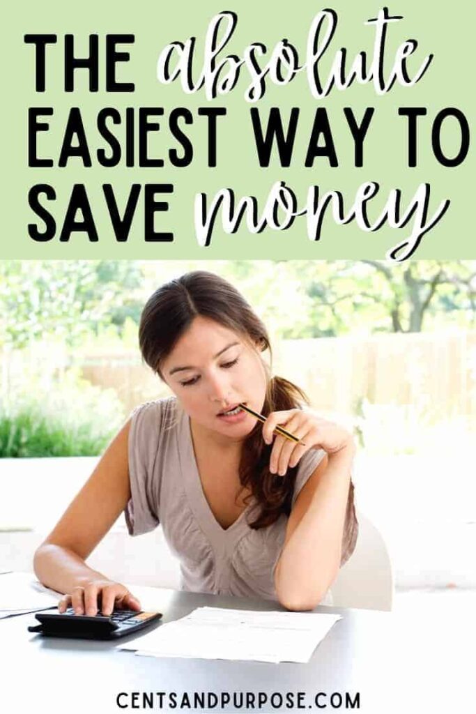 Woman sitting with paper and pen in mouth budgeting with text that reads: The absolute easiest way to save money