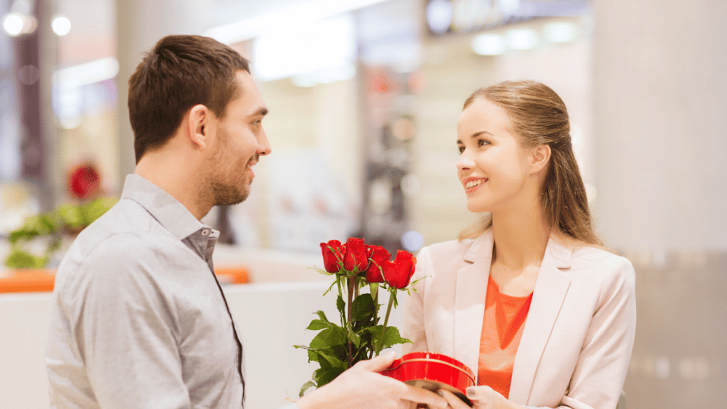 Man giving woman red roses