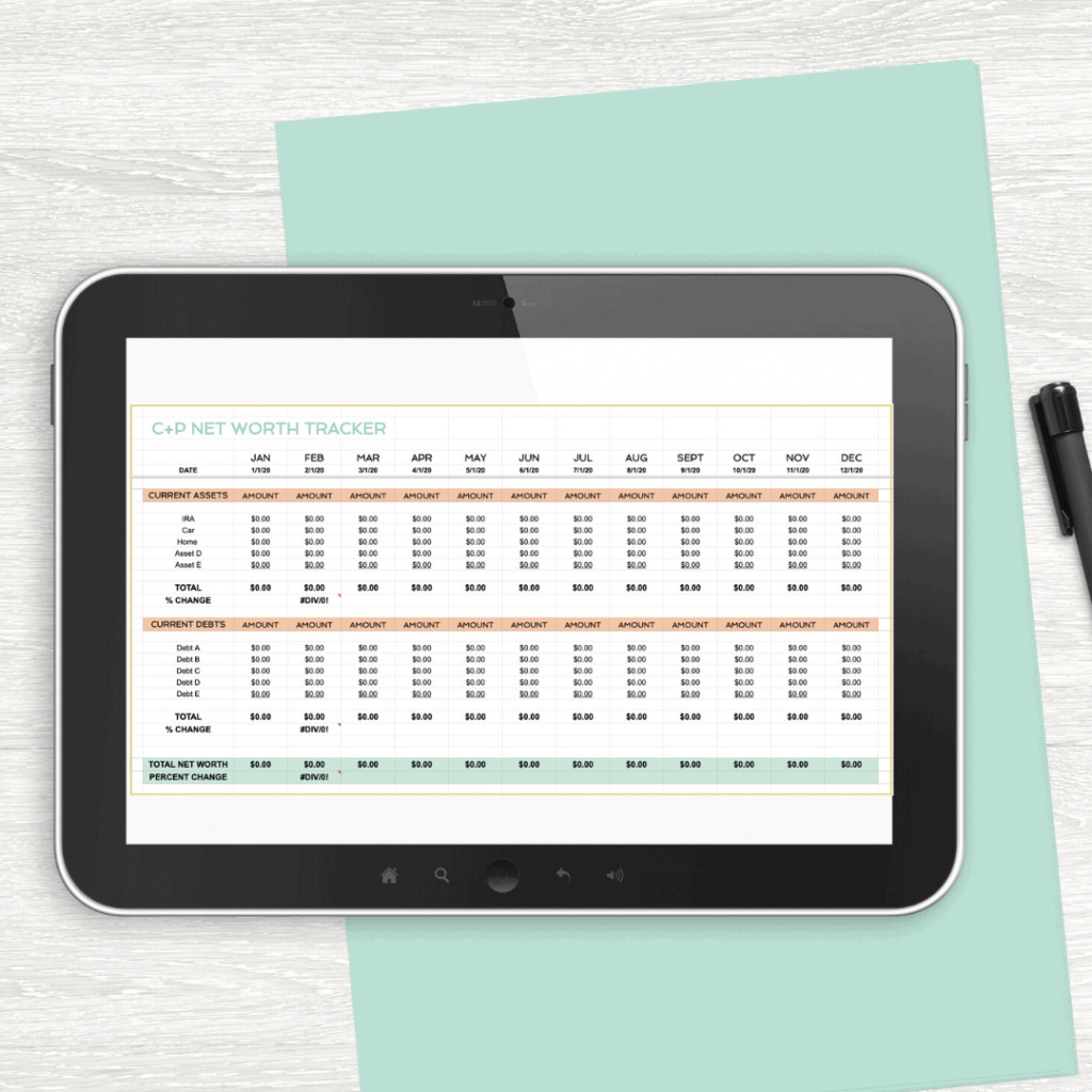 Net worth tracker spreadsheet on tablet with pen and paper