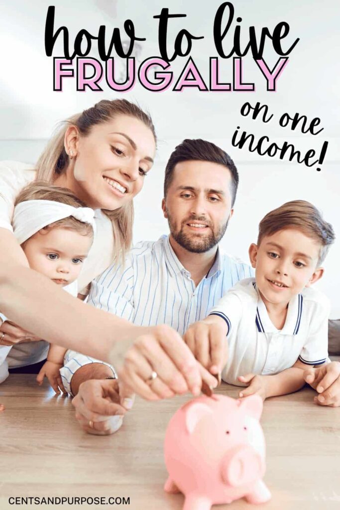 Family sitting at table putting change in a piggy bank with text that reads: How to live frugally on one income.
