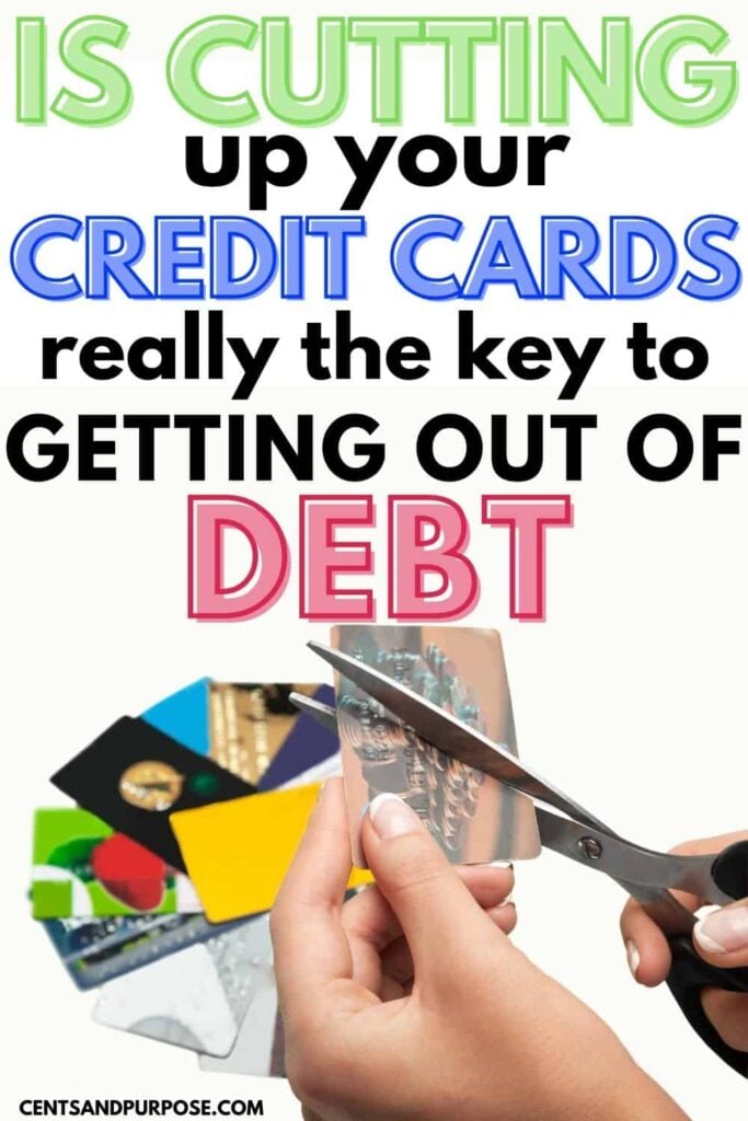 Woman's hands cutting up credit cards with text that reads: Is cutting up your credit cards really the key to getting out of debt