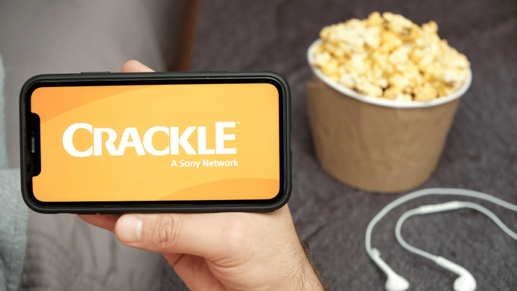 Phone with Crackle free streaming service on it, popcorn, and headphones
