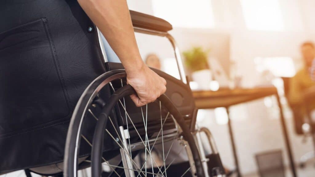 Man wheeling himself in a wheelchair