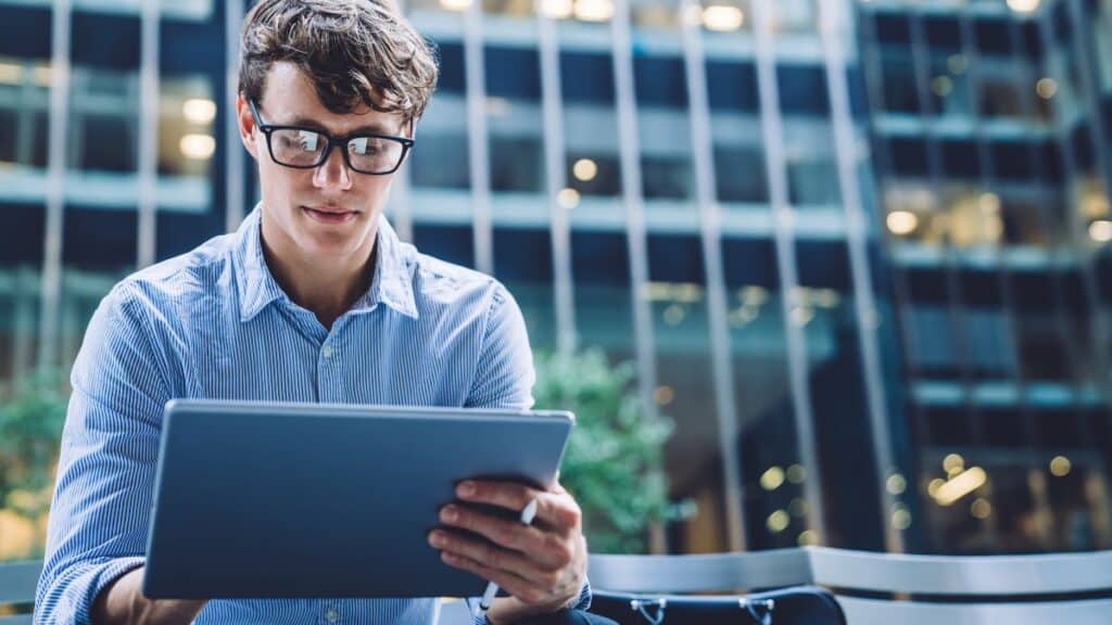 Man sitting outside learning on his laptop