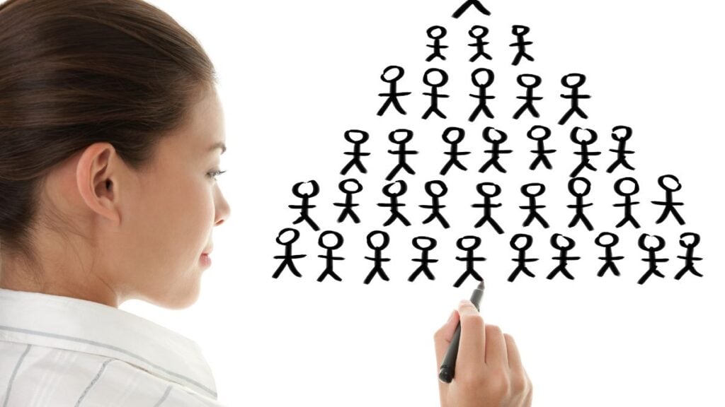 Woman drawing stick figures on white board