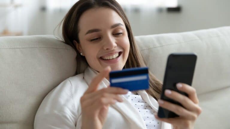 Woman making a purchase with her credit card using her phone
