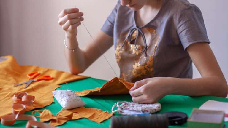 Woman sewing fabric together