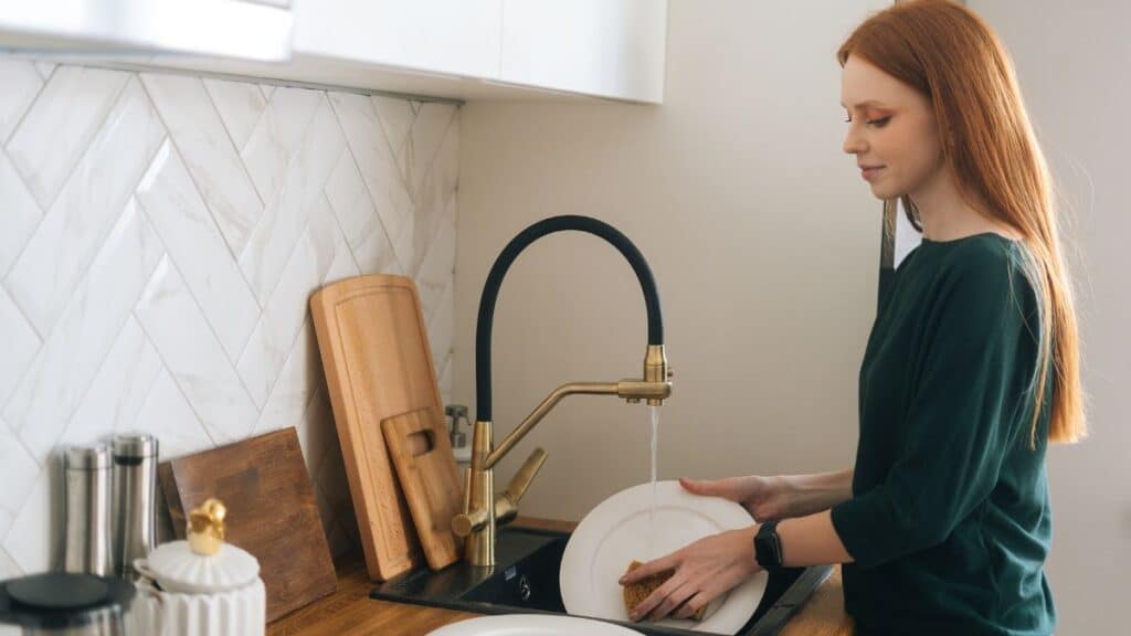 Woman doing dishes in kitchen