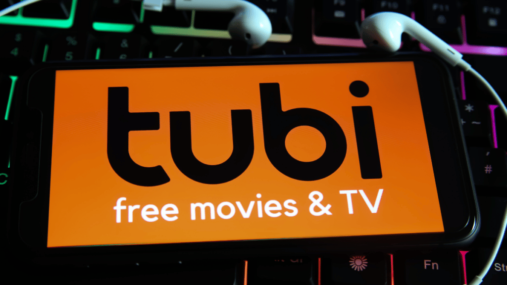 Phone with free streaming service Tubi on screen and headphones