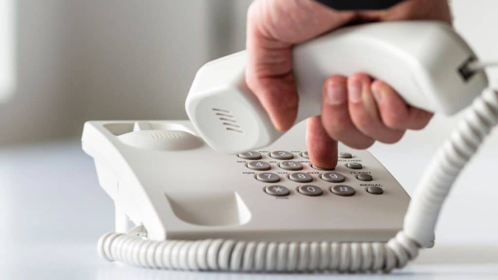 Person dialing a landline phone