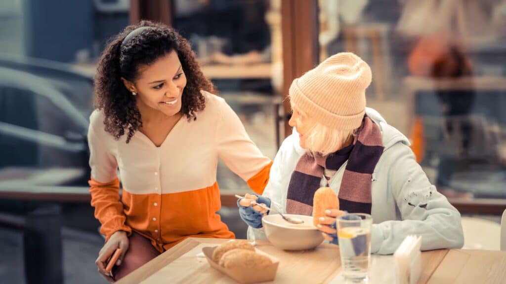 Nice woman speaking to an elderly woman