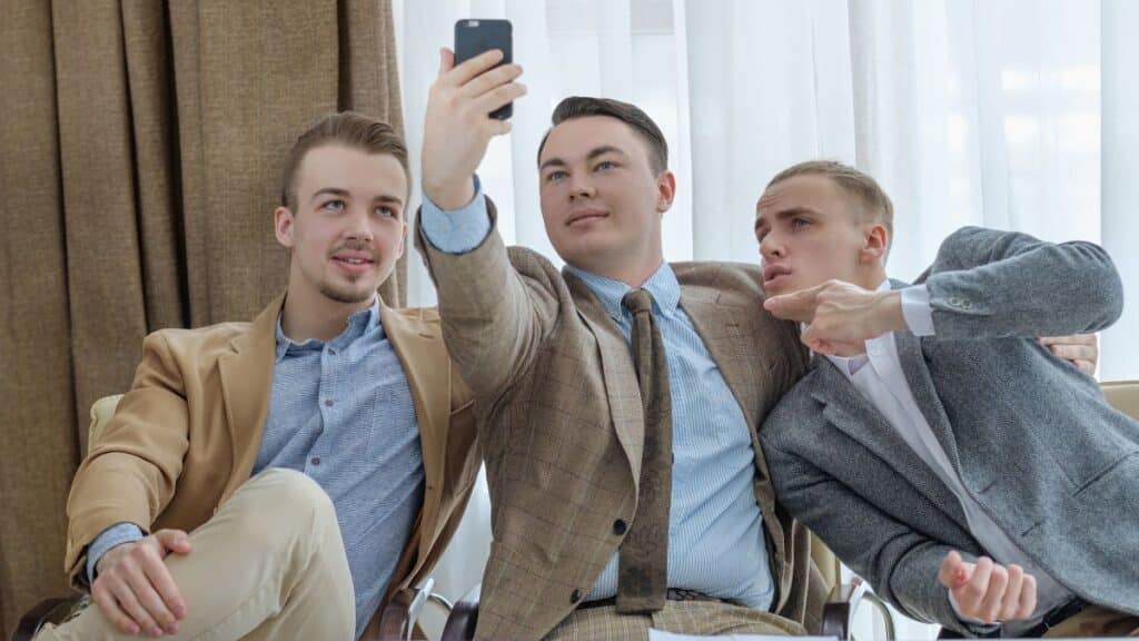 Group of guys wearing sport coats taking a selfie togther