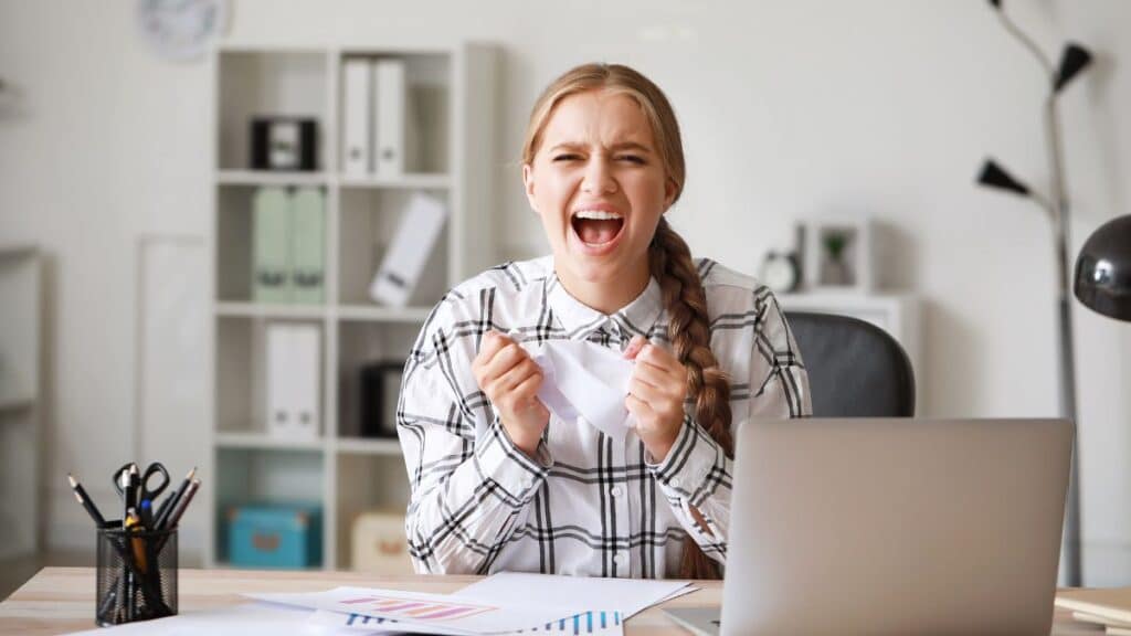 Happy female employee sitting at her desk