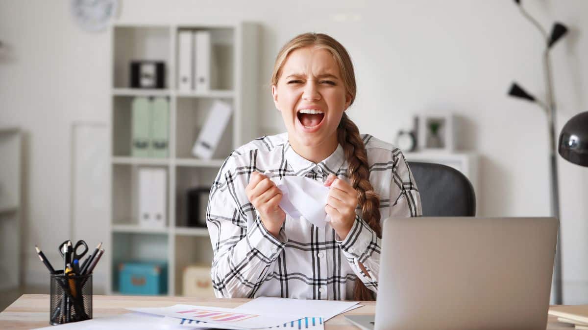 Happy female employee sitting at her desk