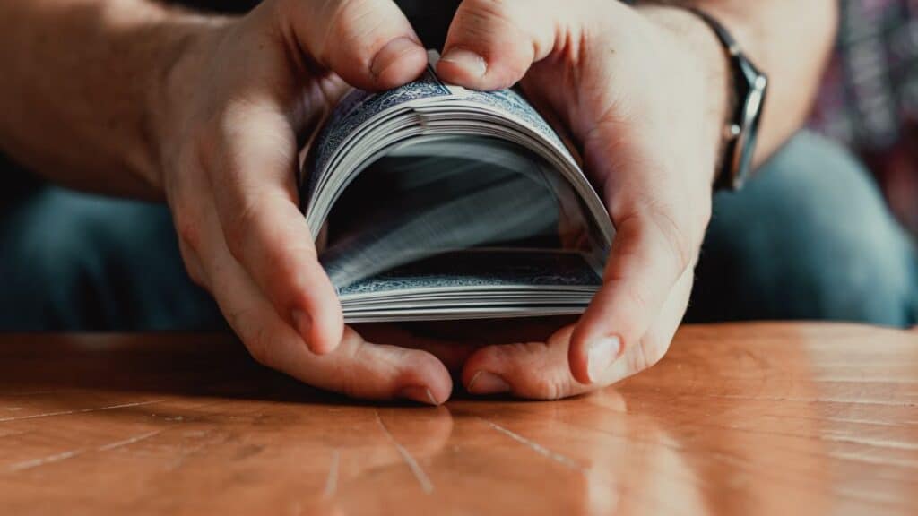 Hands shuffling a deck of cards