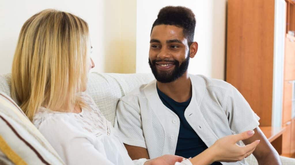 Man and woman sitting on the couch talking