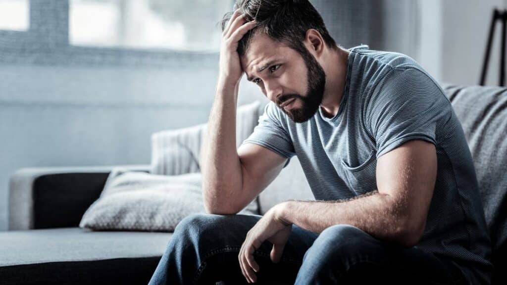 Man looking sad sitting down