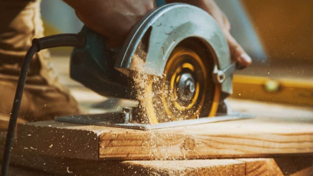Person using a table saw to cut a board