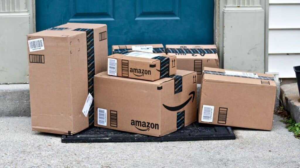 Front porch with large pile of Amazon packages in front of door