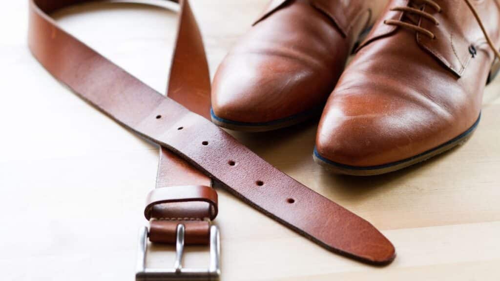 Man's brown leather belt and shoes