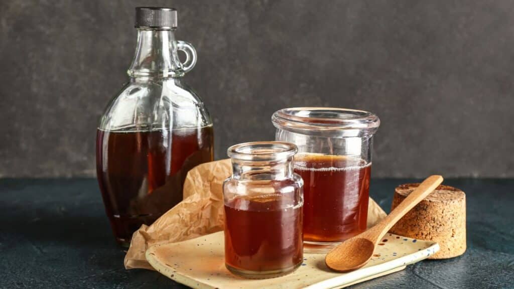 Jars of maple syrup on a plate