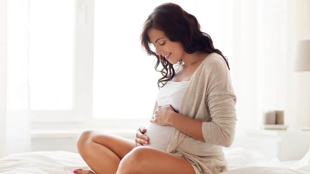 Pregnant woman holding her belly