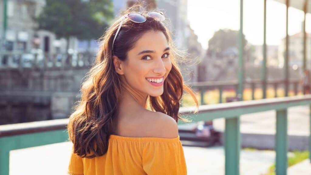 Happy 30-year old woman looking over her shoulder