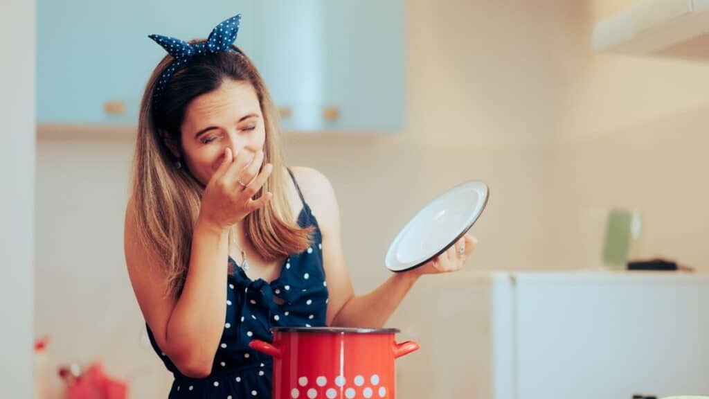 Woman cooking something in a pot that smells awful