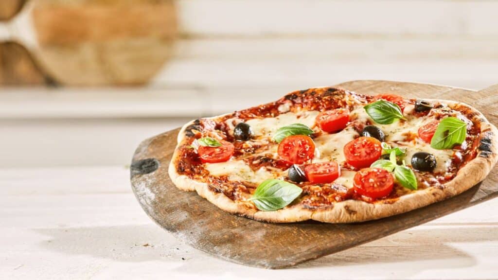 A pizza with different veggies on it.