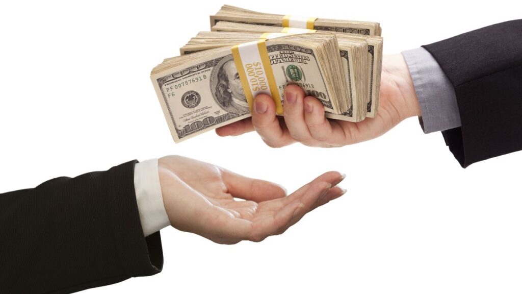 One man giving another man cash