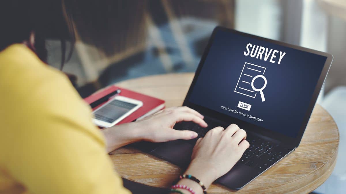 Woman completing an online survey on her laptop