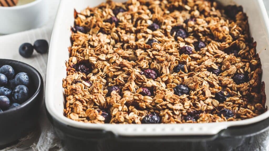 A baking dish with oven baked oats and blueberries.