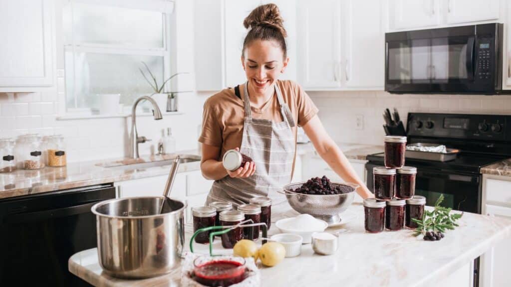 Woman canning at her kitchen island