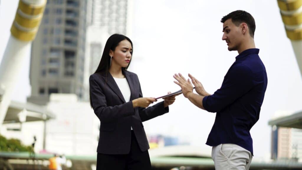 Man saying no to saleswoman