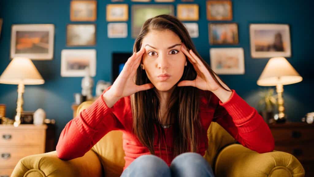 Woman holding her head like she's thinking