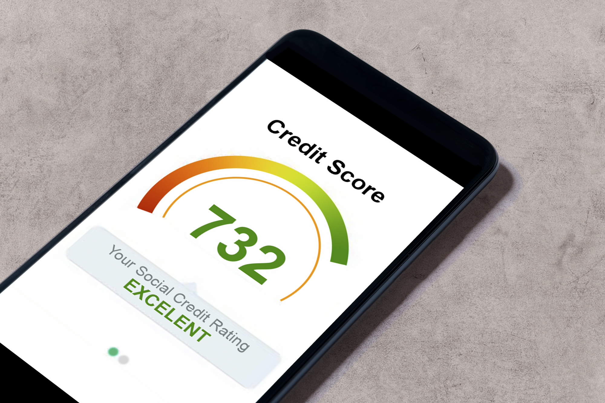 Cell phone laying on table with credit score showing on the screen