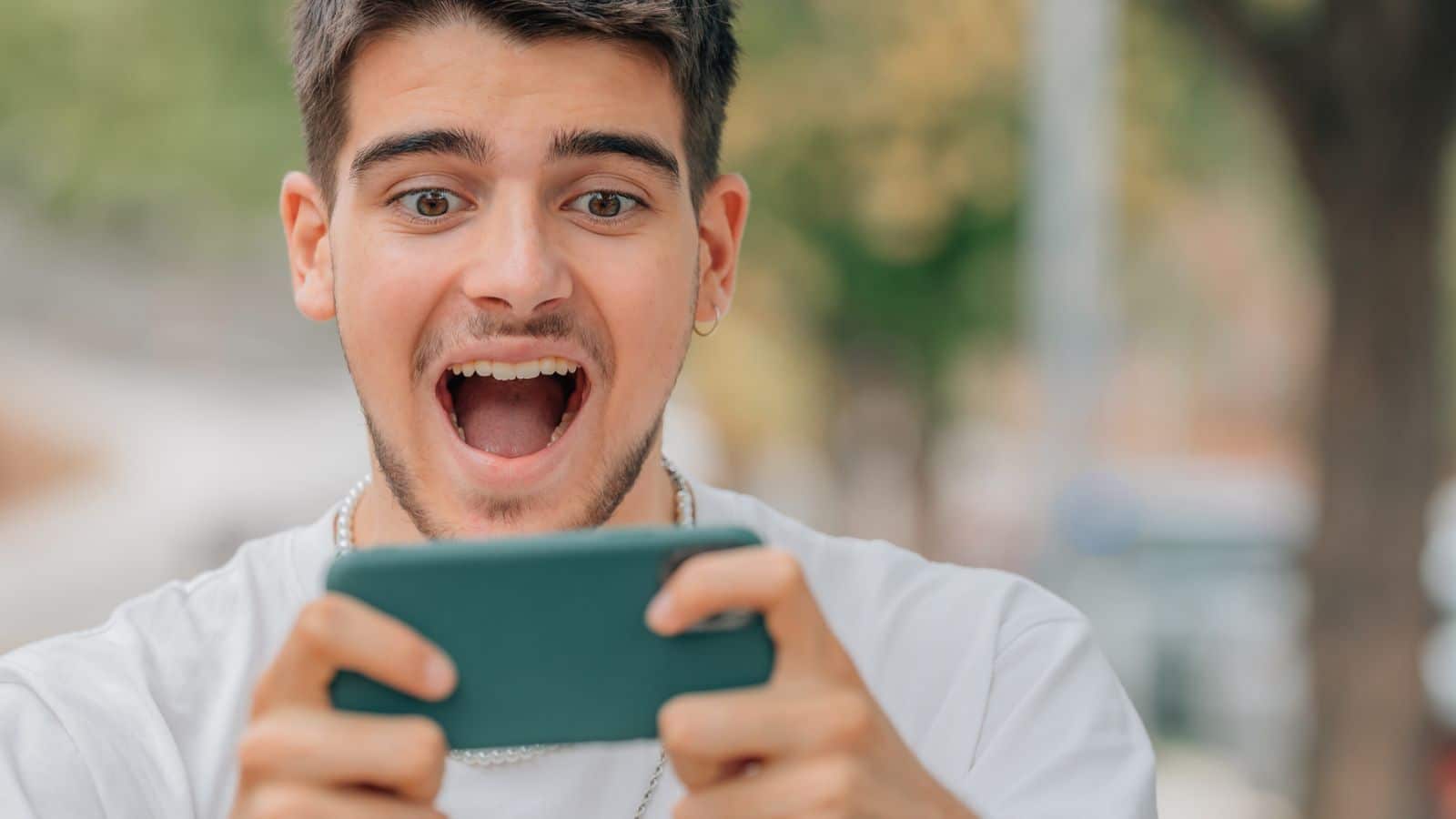 Young man playing a game on his mobile phone