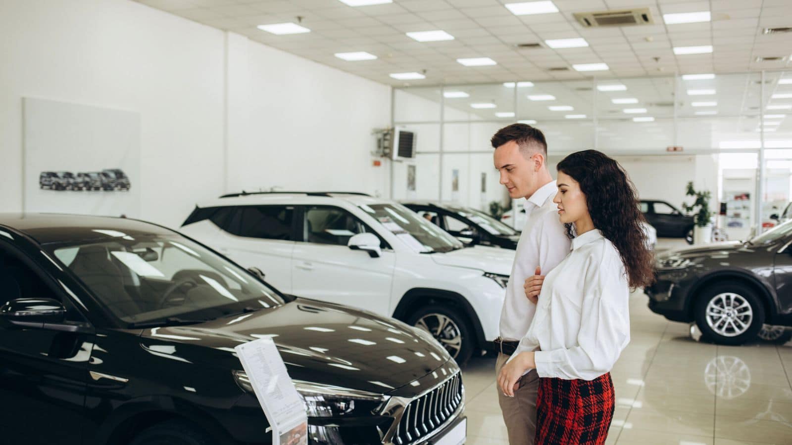 Couple car shopping indoors