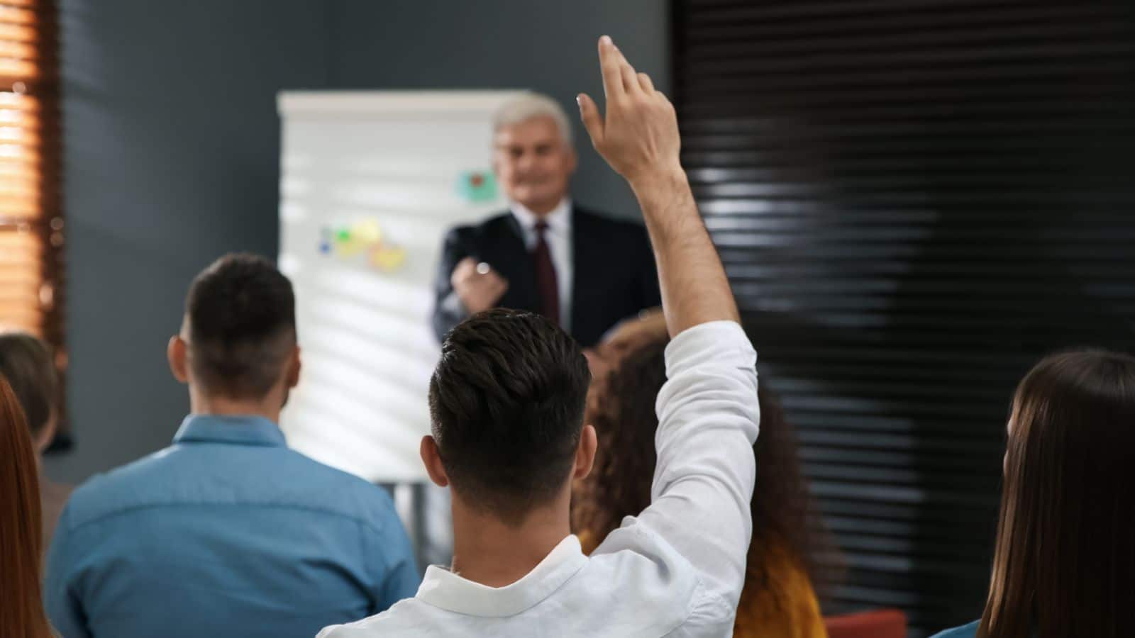 People in class raising hands