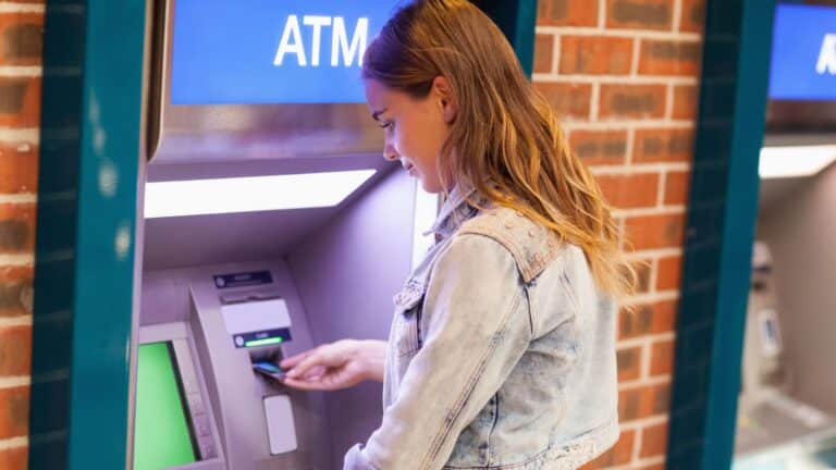 Young woman at an ATM machine