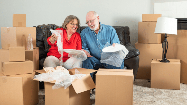 Retired couple moving and unpacking boxes