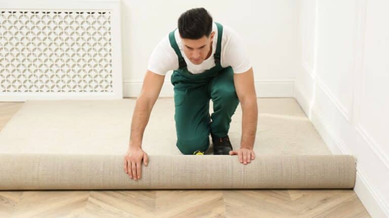 Carpet installer rolling out new carpeting