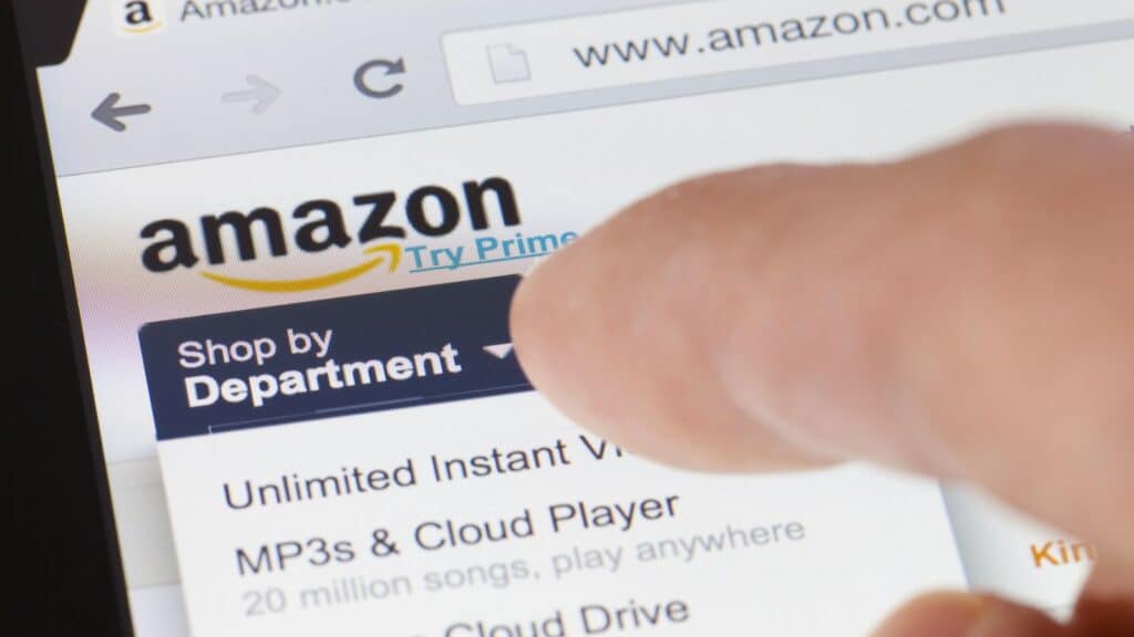 Man's finger pointing to something on the Amazon website