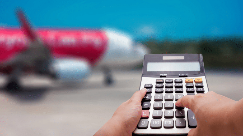 Person using a calculator near an airplane