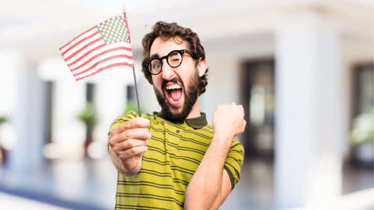 Dumb American man holding a small flag and making a funny face