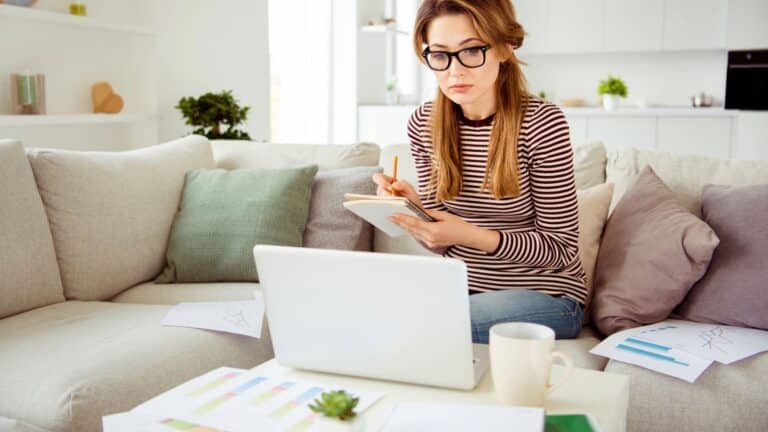 Young woman budgeting at her coffee table
