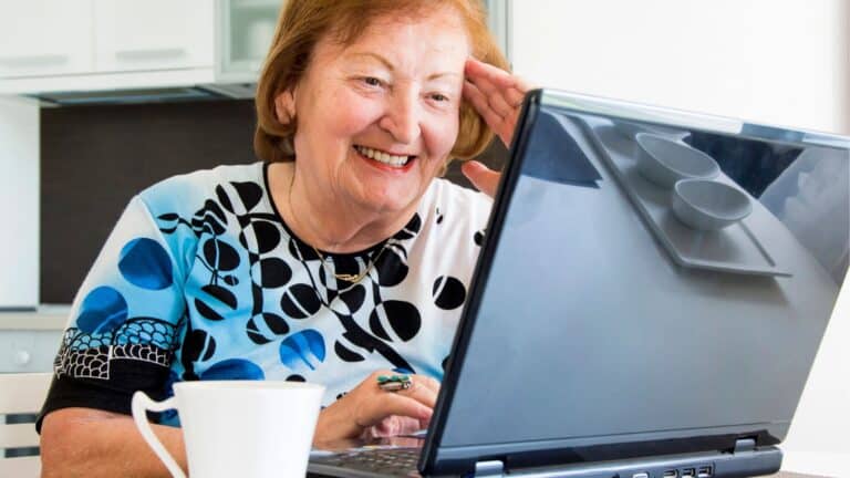 Retired woman working at her laptop
