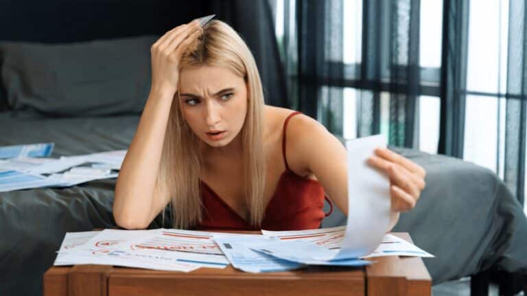 Woman looking stressed while looking at a receipt