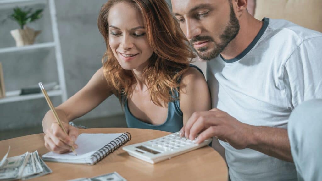 Couple sitting at table working on their budget